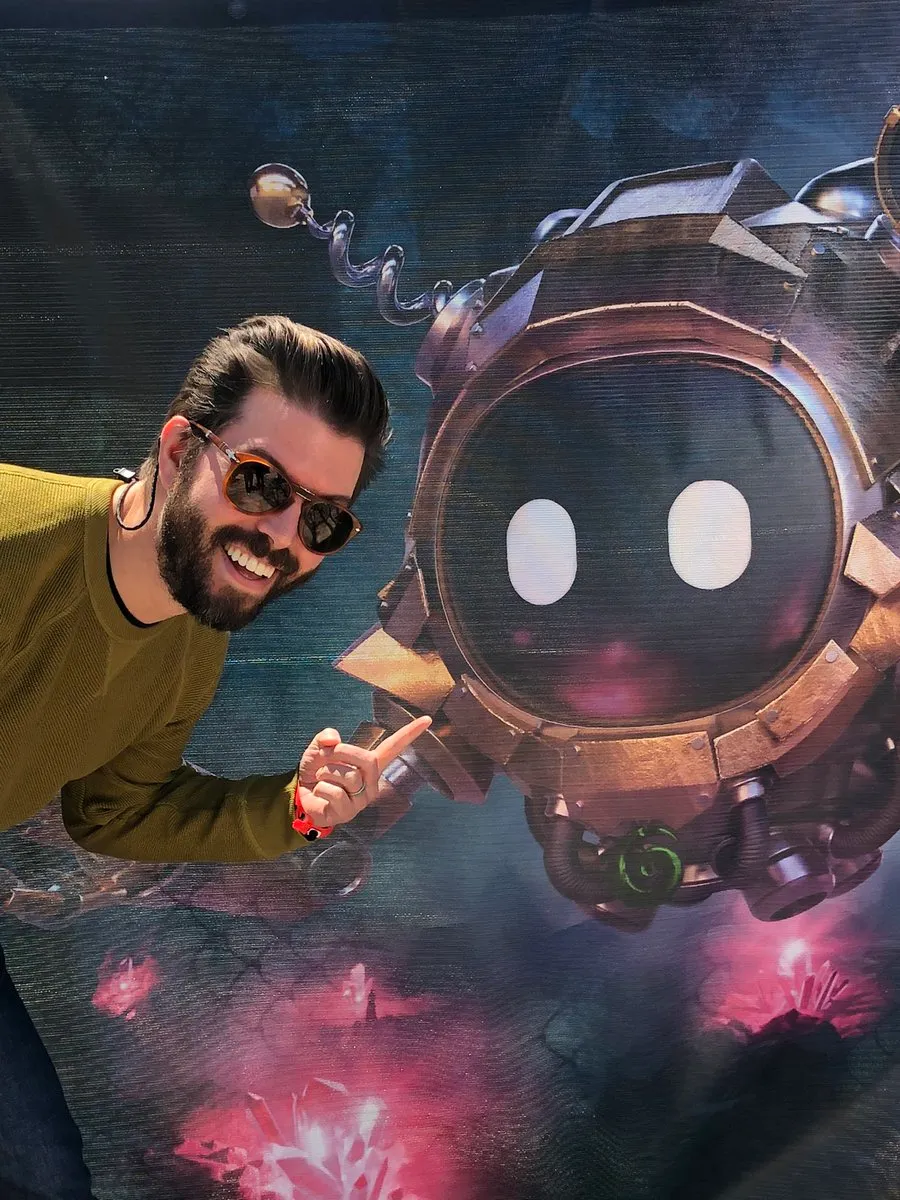 Person smiling beside a large round Seeker character display.