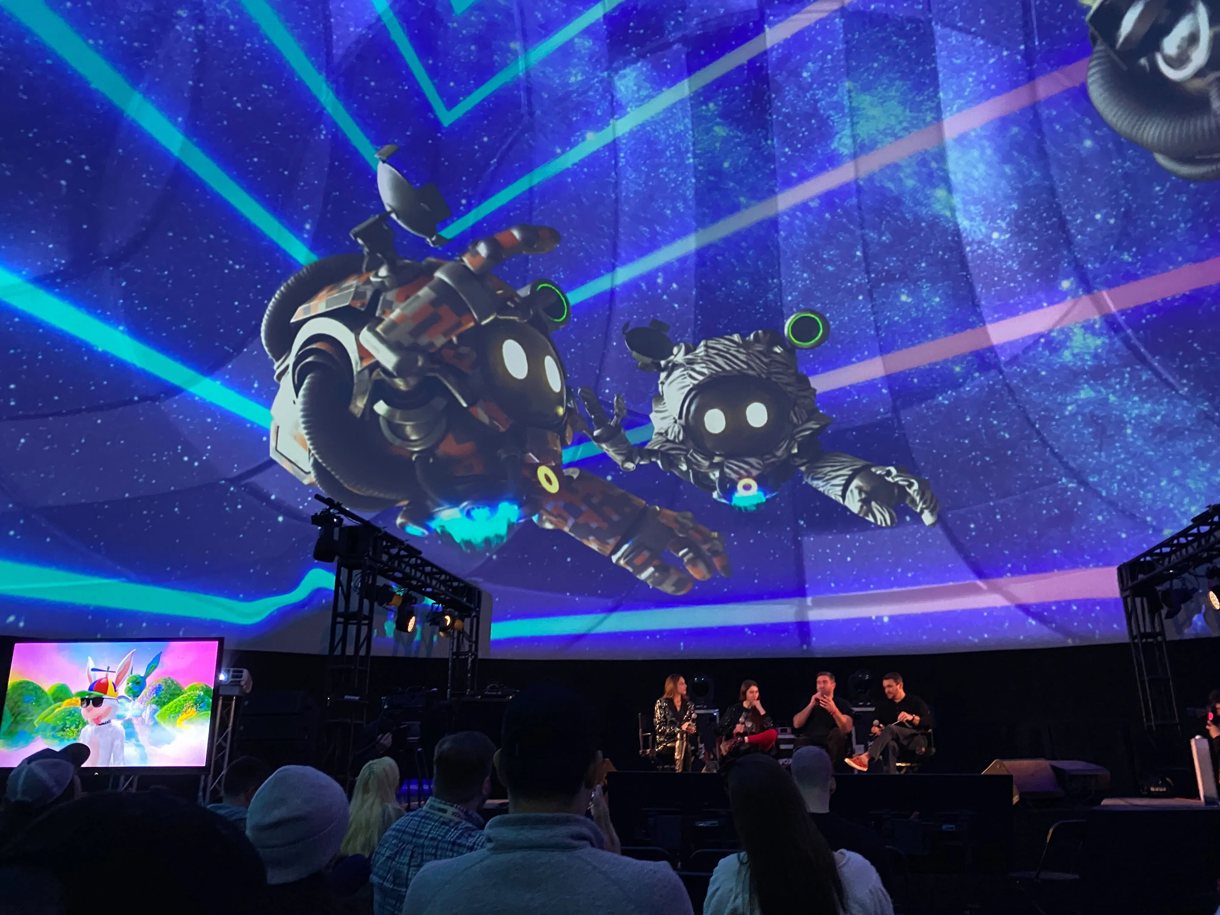 Seekers projected across a large SXSW stage dome during a panel.