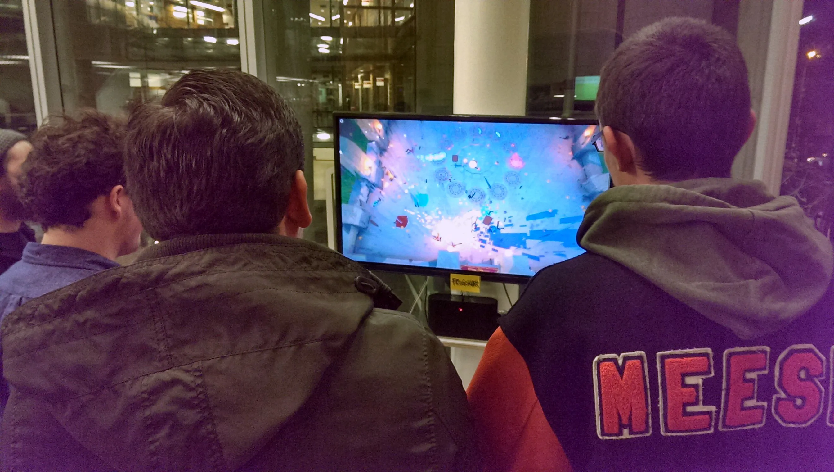 Players watching Swordy on a monitor during an in-person playtest.